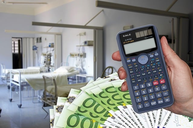 Vivna Health Insurance | Hand holding calculator in hospital room