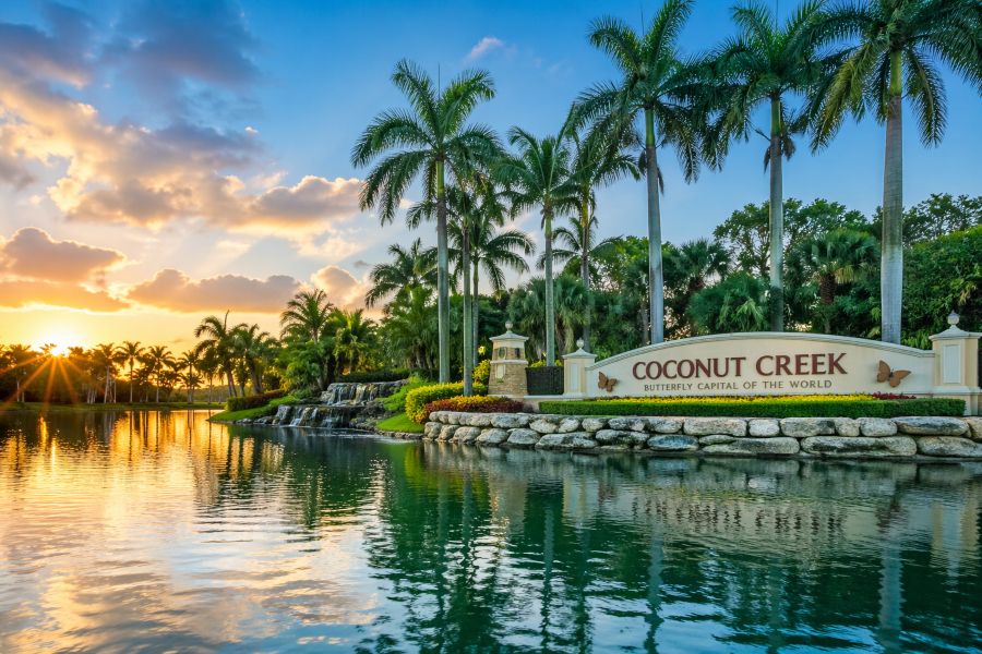 Health Insurance in Coconut Creek FL | Coconut Creek Florida city entrance with palm trees lake and sunset view